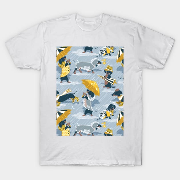 Ready For a Rainy Walk // pattern // pastel blue background dachshunds dogs with yellow and transparent rain coats T-Shirt by SelmaCardoso